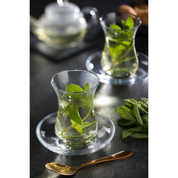 Two Utopia Aida Tea Glasses with mint leaves and spoons on a table.