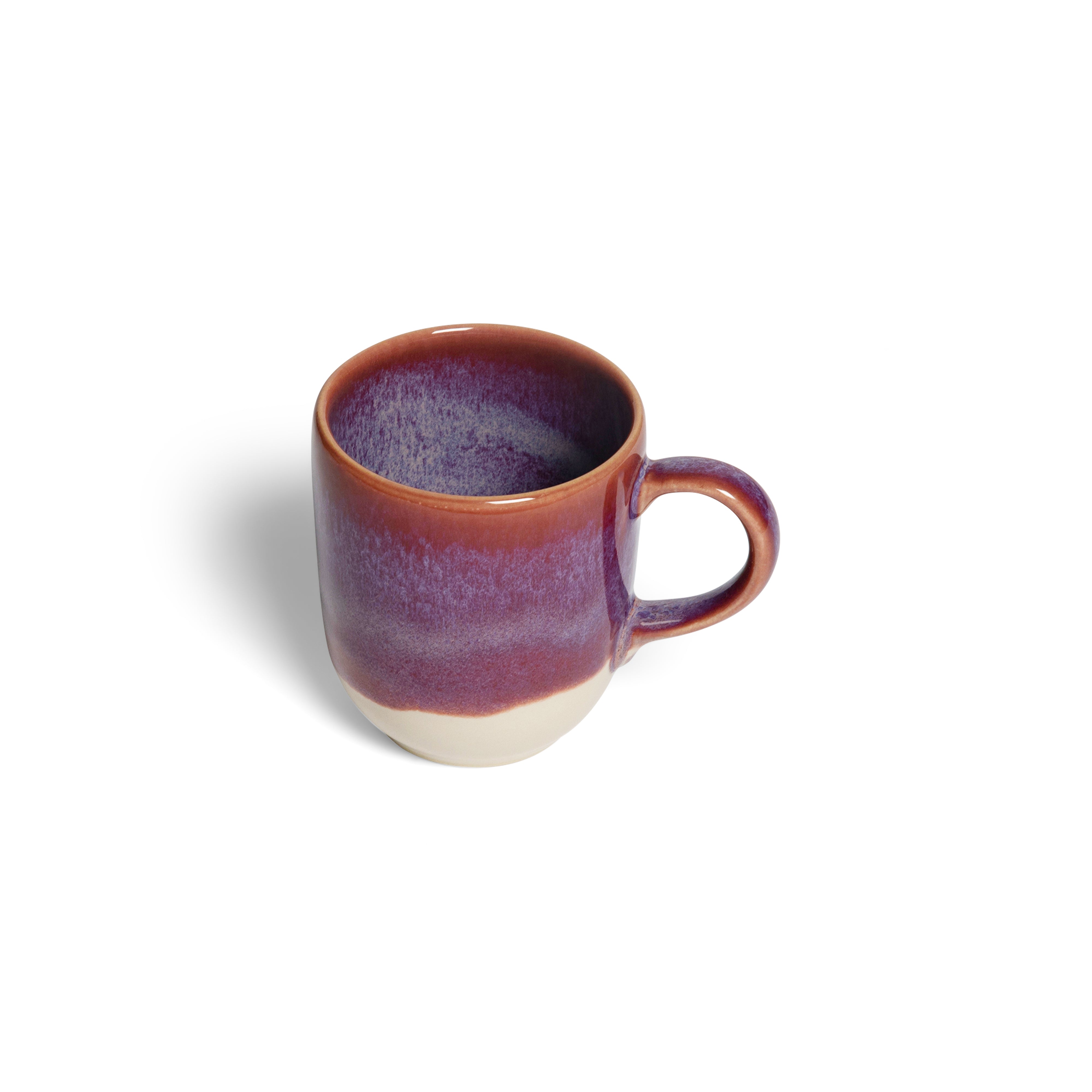 Ceramic mug with purple glaze on a white background