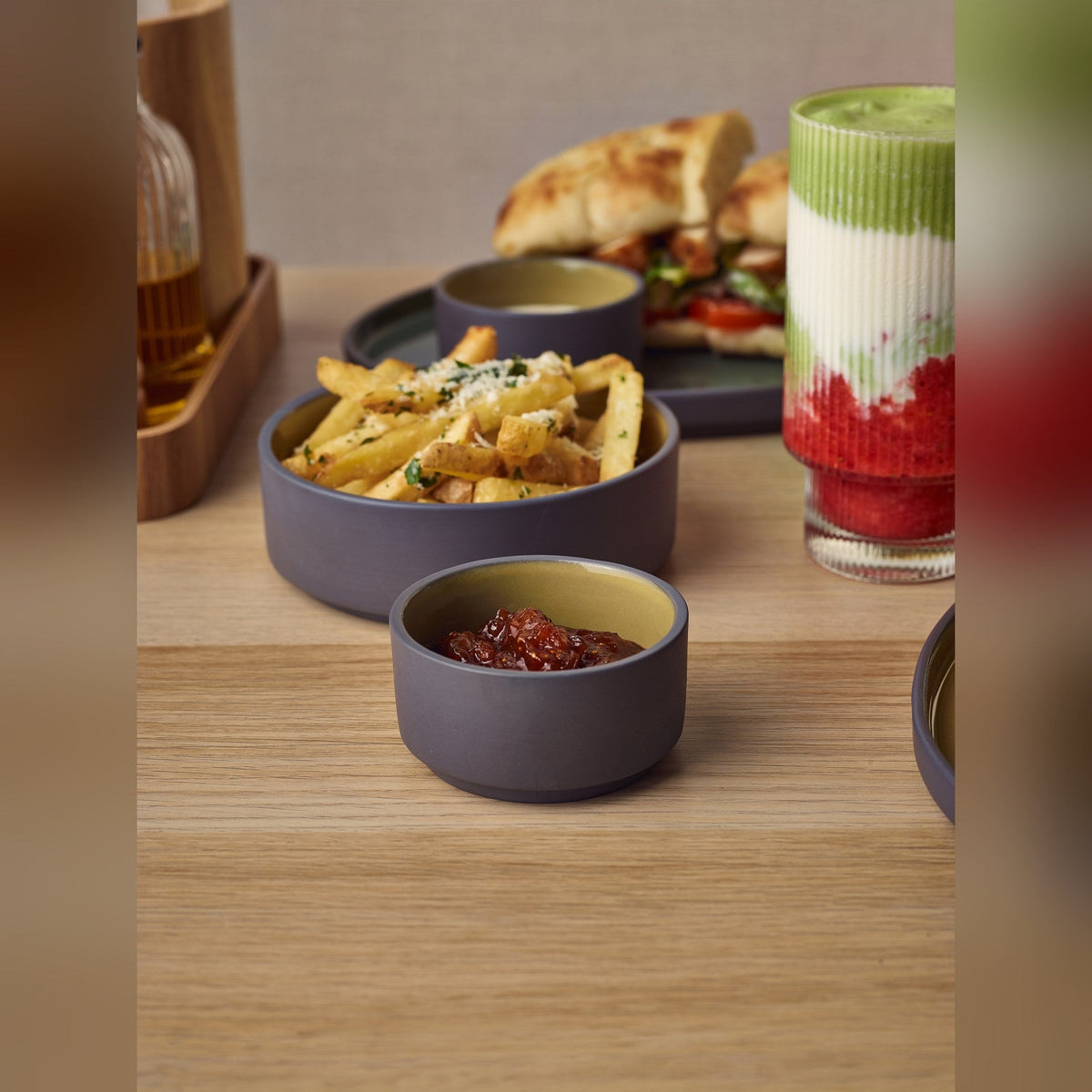 Kava yellow satin glaze porcelain ramekin 7.5cl with exposed grey wall, lifestyle image