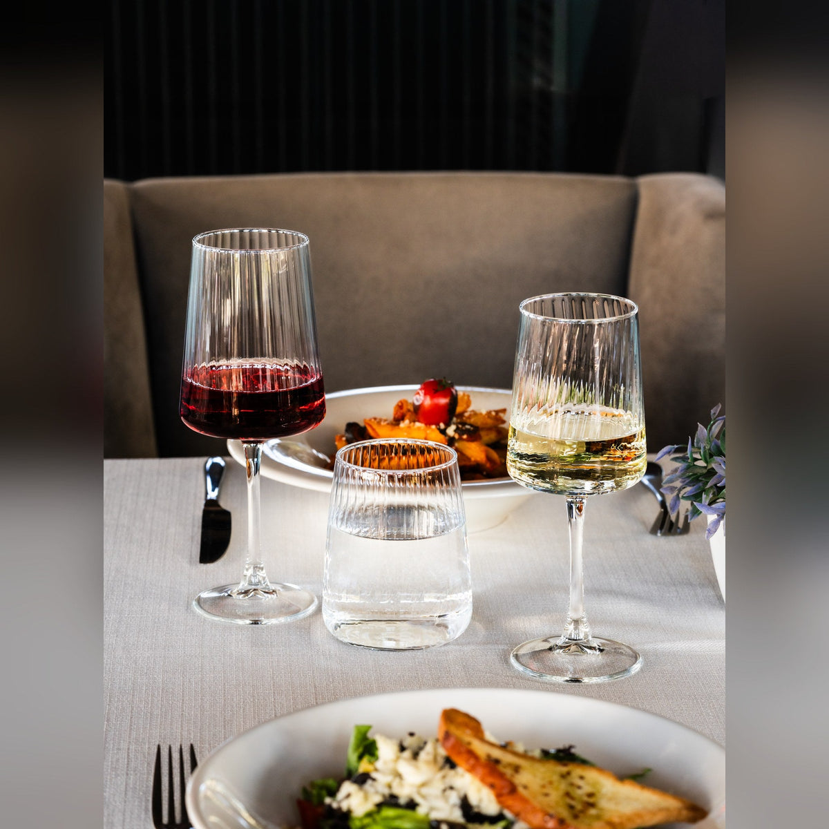 Modena crystal-look wine glass 35cl with striated bowl, lifestyle image