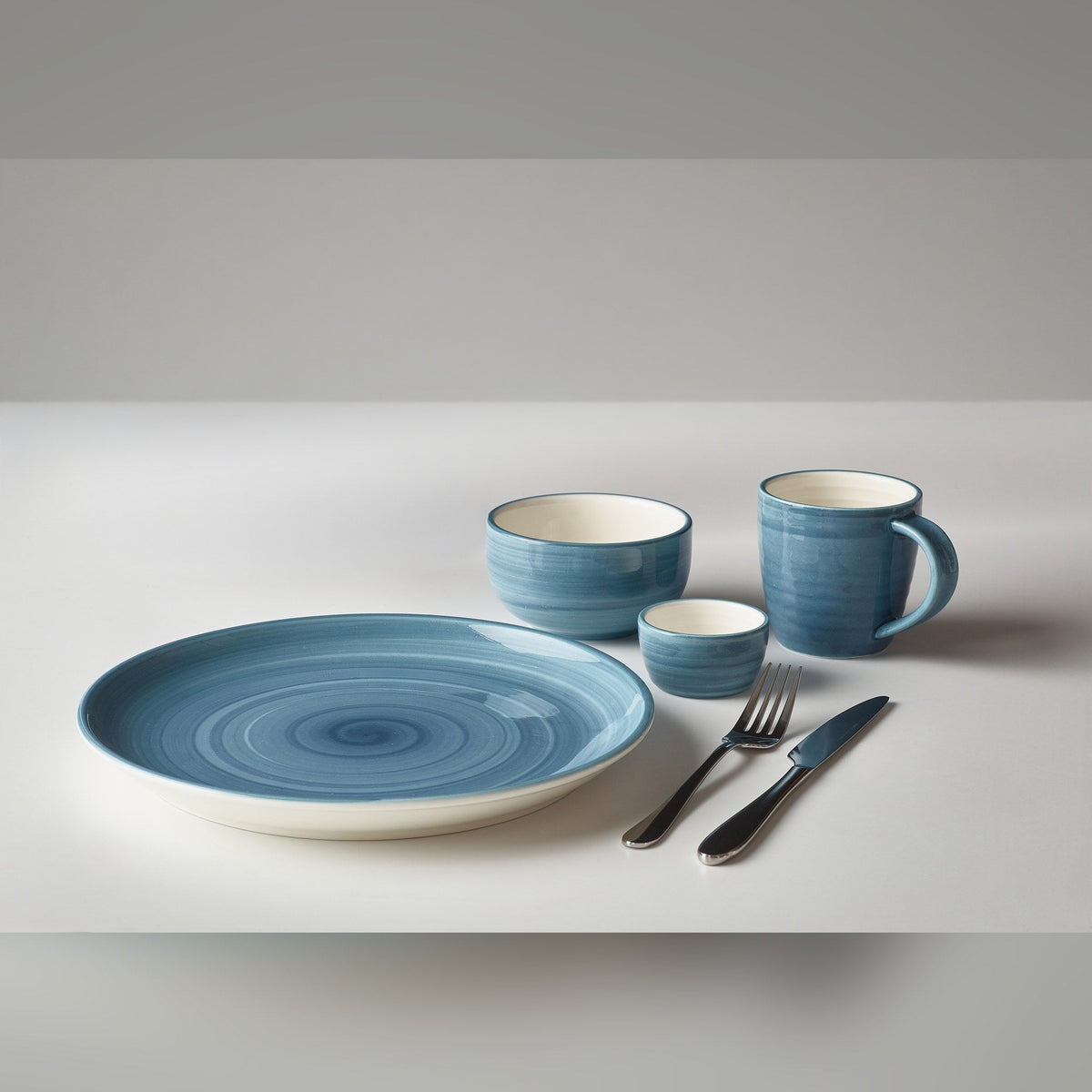 Miro blue porcelain round bowl 11.5cm with reactive style glaze, lifestyle image